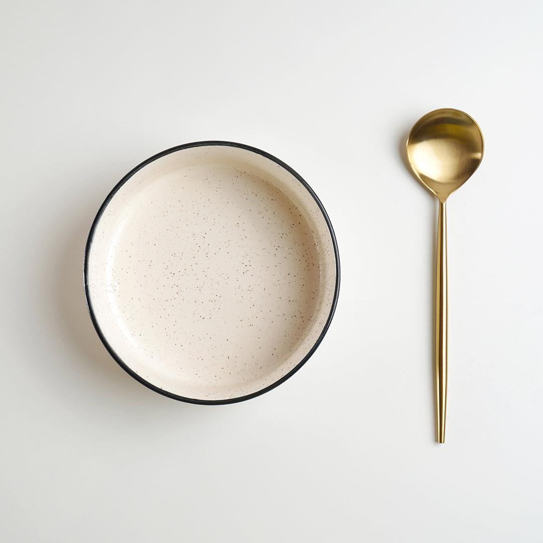 Ceramic bowl with metal spoon