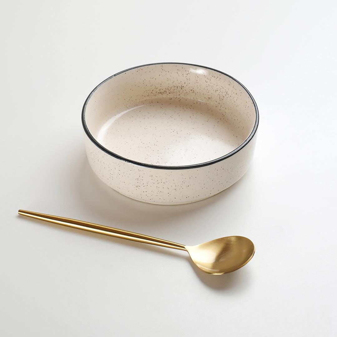 Ceramic bowl with metal spoon